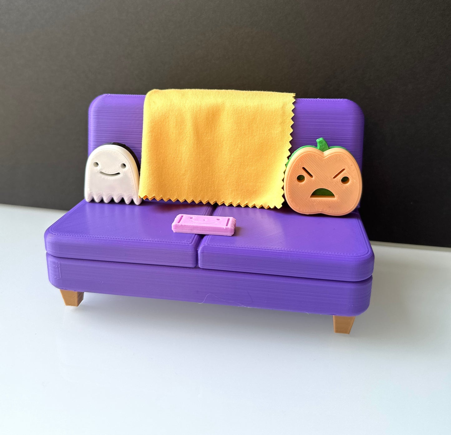 The Halloween Colab Couch Phone Holder with Candy Bar and Ghost + Pumpkin Pillows