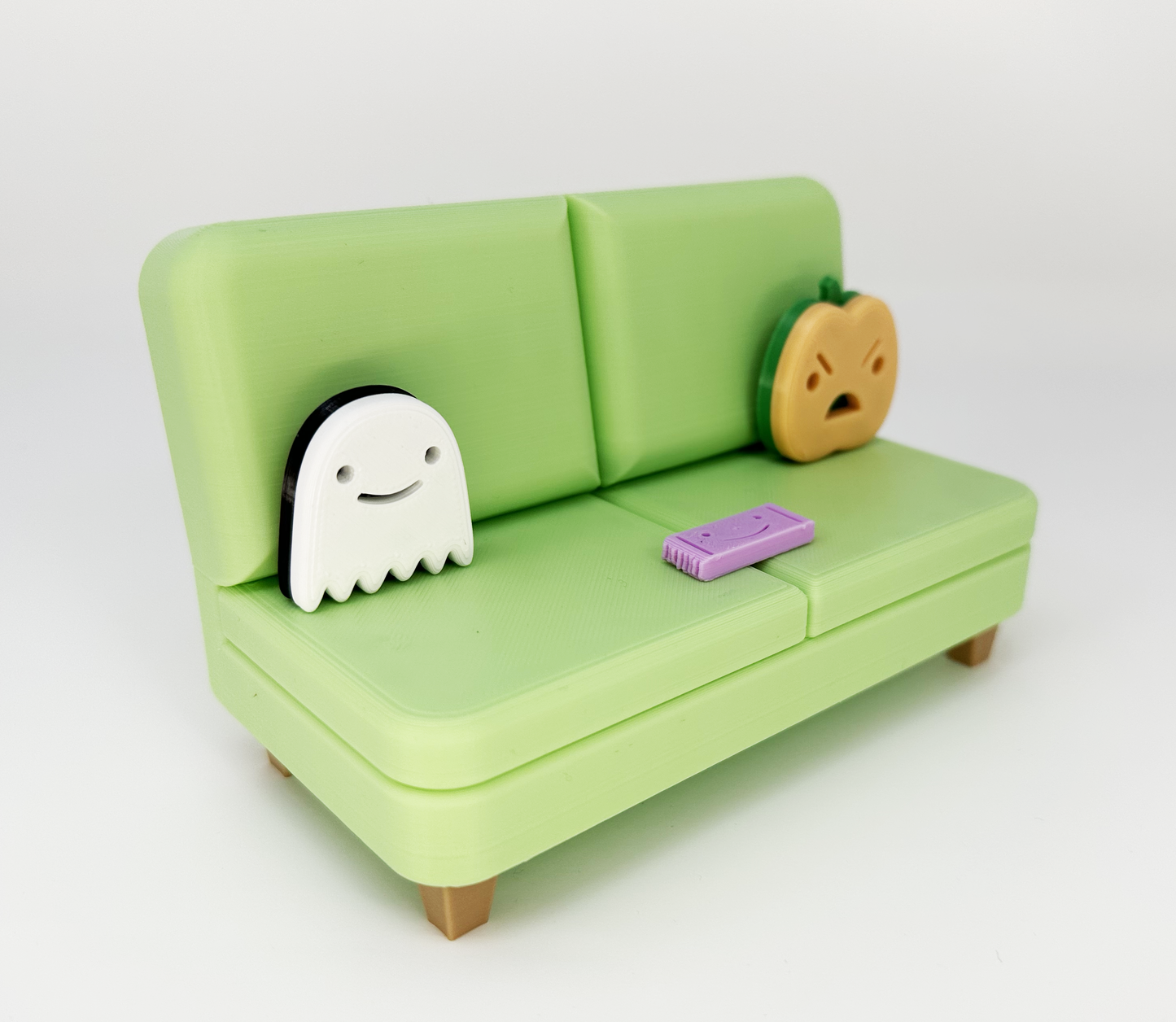 The Halloween Colab Couch Phone Holder with Candy Bar and Ghost + Pumpkin Pillows